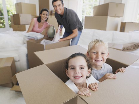 Packed moving boxes and furniture ready for transport in Islington