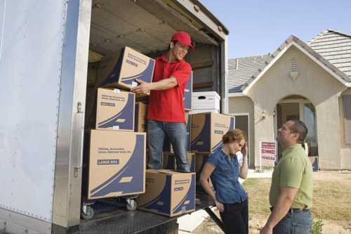 Professional movers carrying belongings in an Islington apartment building