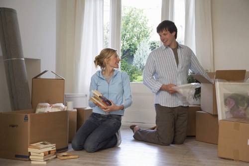 Professional house movers transporting furniture and boxes in Islington