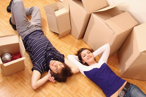Professional movers carrying items through an Islington property
